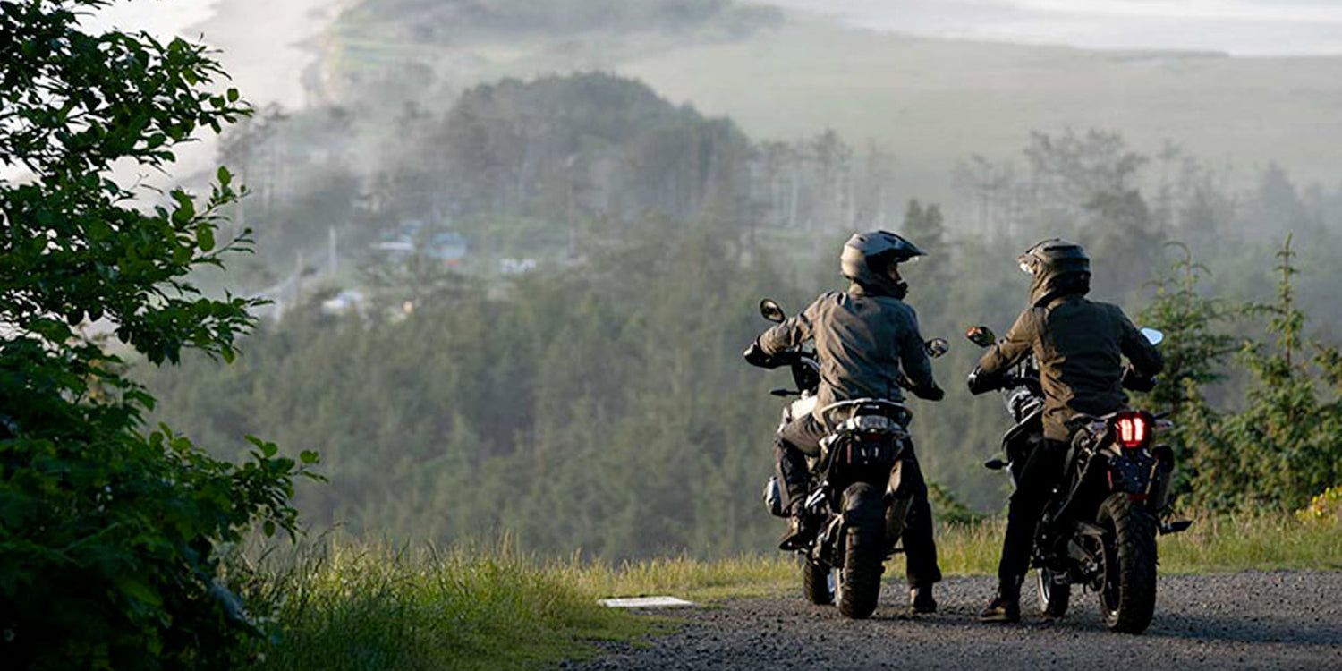 two motorcycle riders forest
