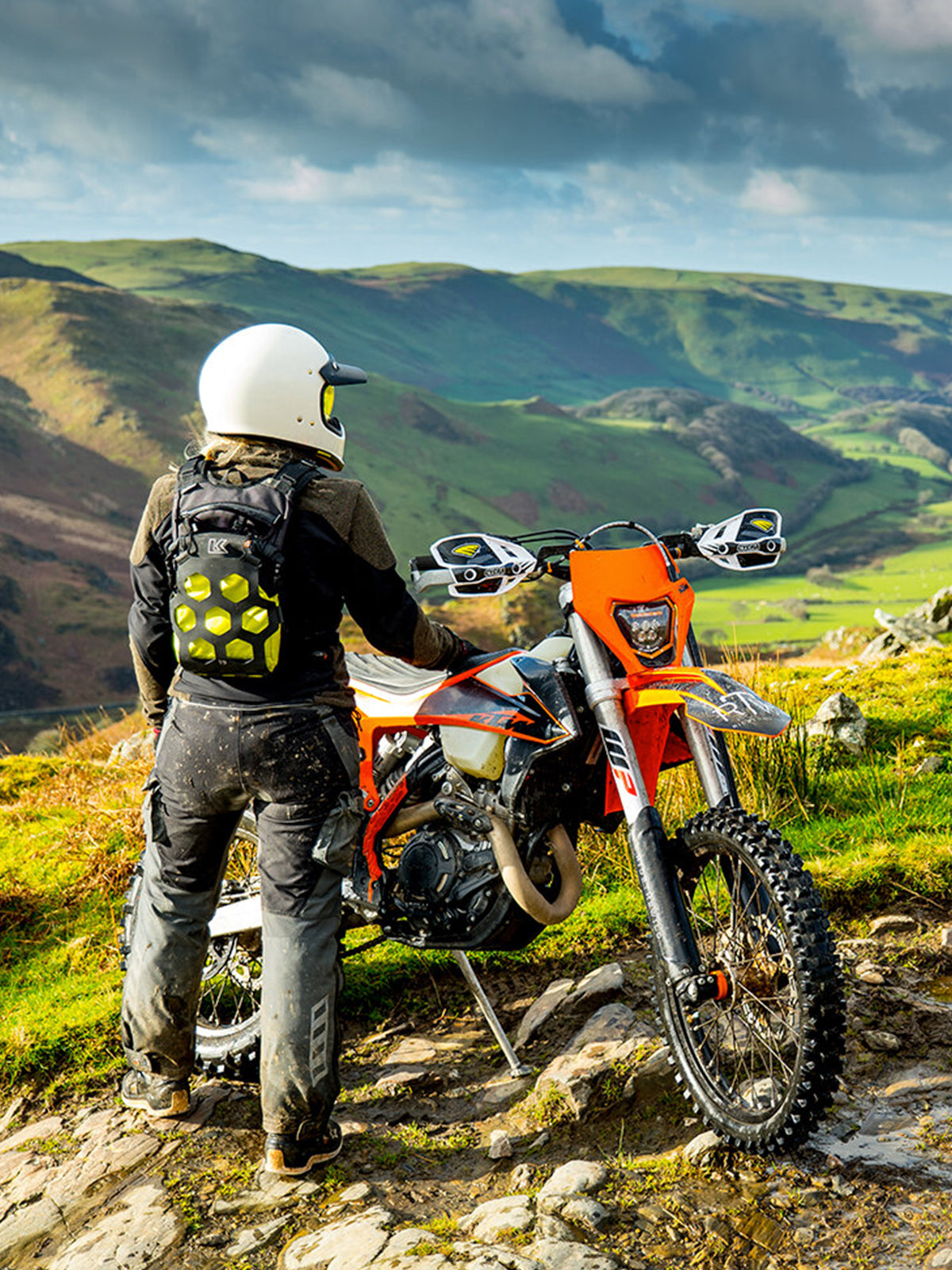 motorbike rider wearing the Kriega Trail9 Adventure Backpack in the mountains
