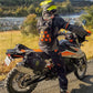 motorcycle rider wearing Kriega Trail9 Adventure Backpack next to a river