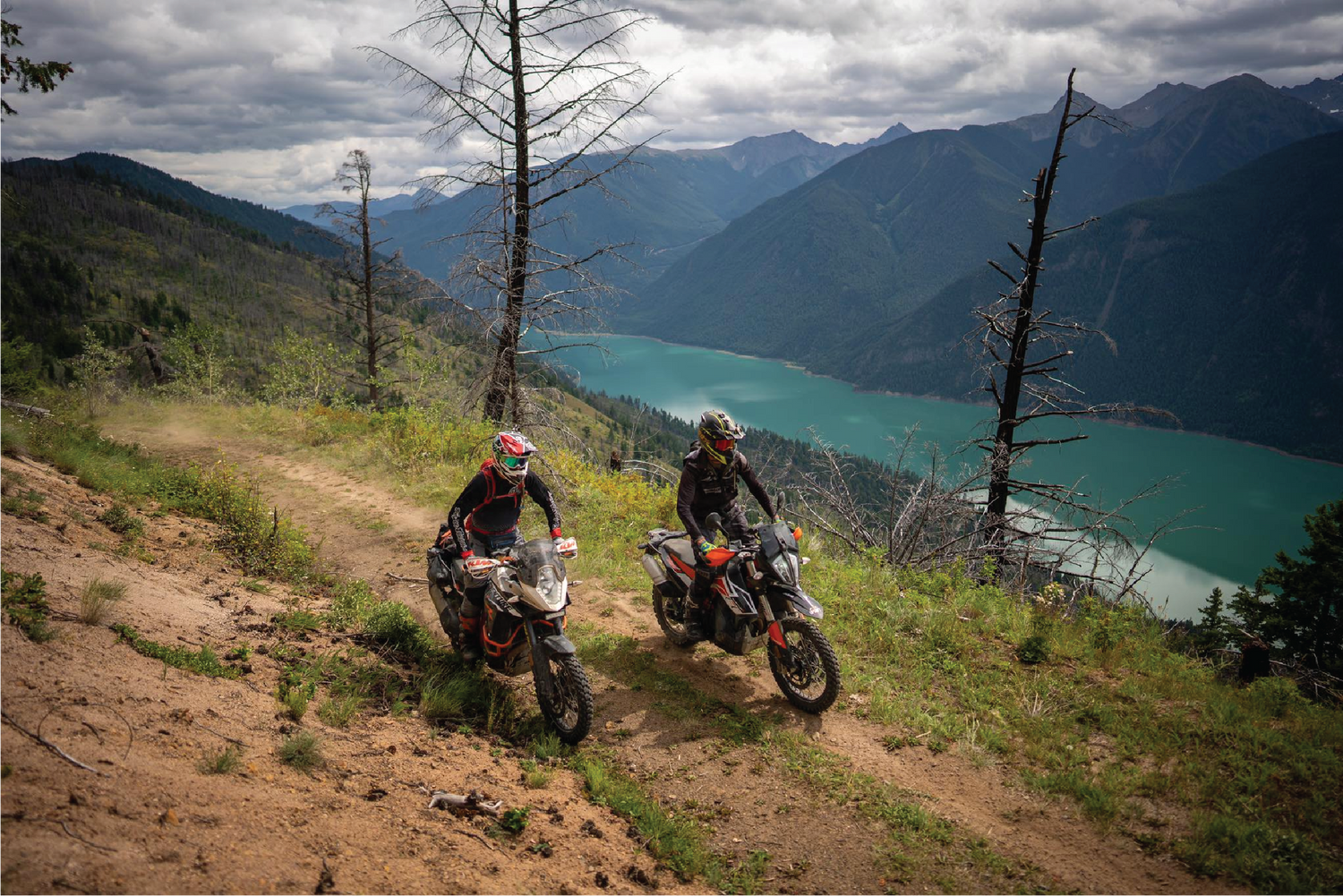 two adventure motorcycle riders in mountains