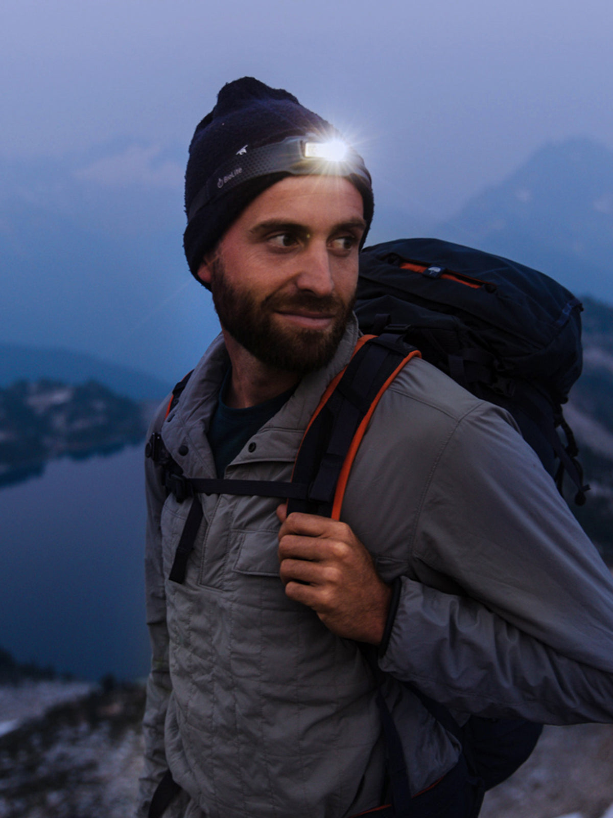 man wearing BioLite Head Lamp 200 in the mountains