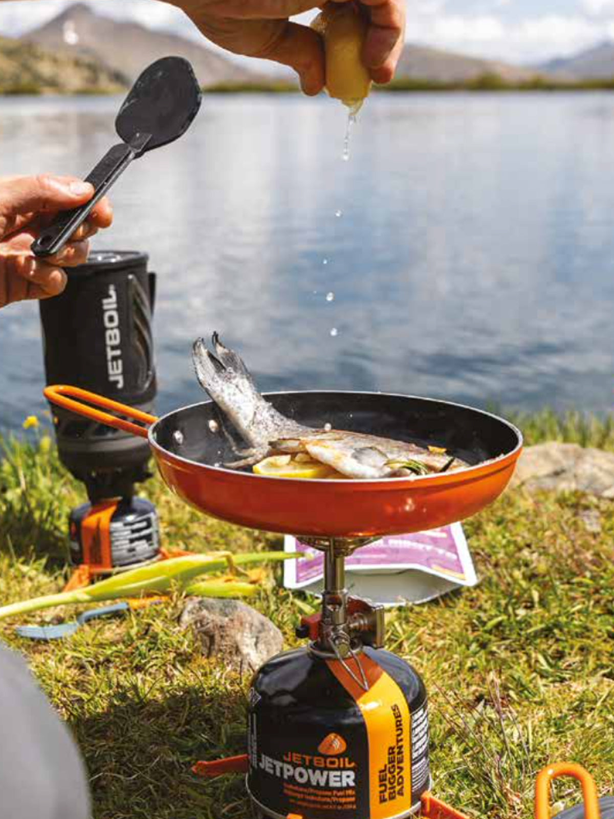 Jetboil MIGHTYMO Stove being used to cook fish in pan