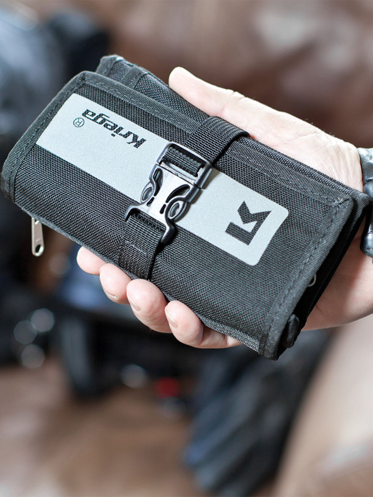 Kriega Stash Wallet in riders hand